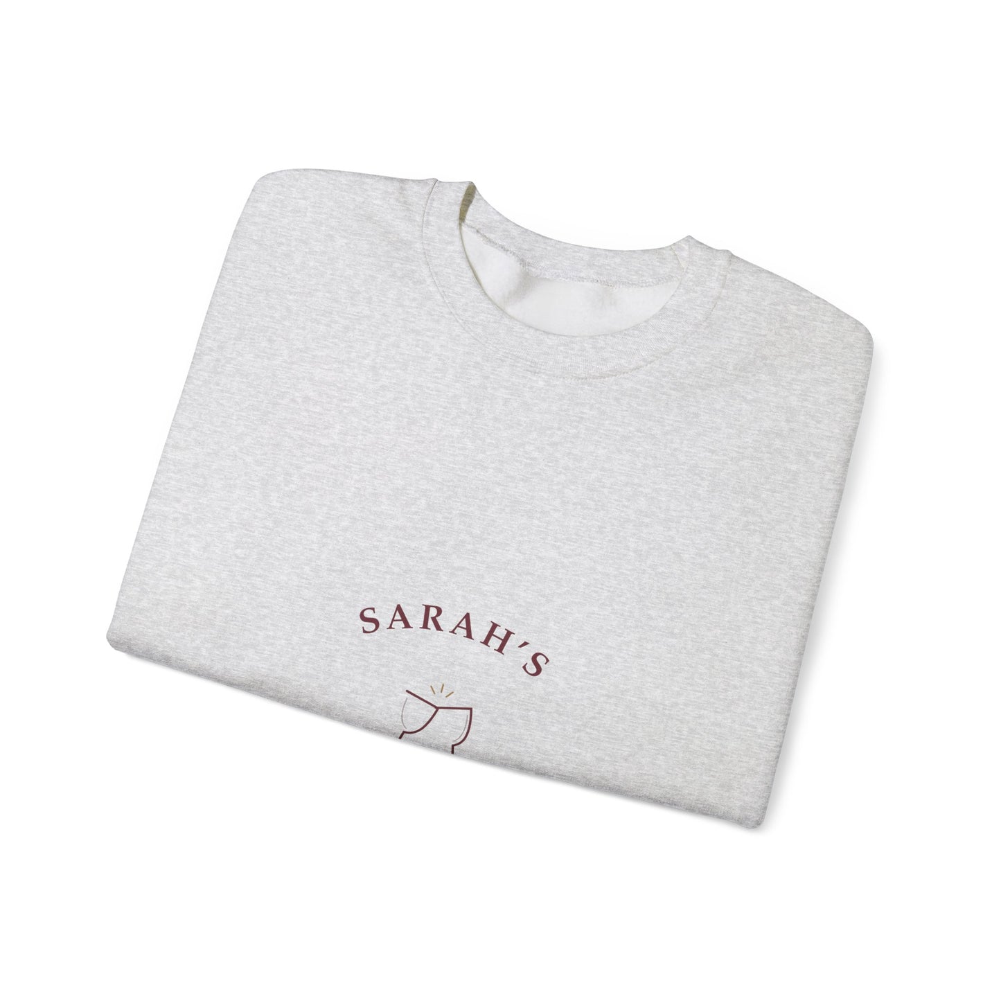 Folded ash grey crewneck showing a close-up of the wine-colored Weekend Wine Club lettering