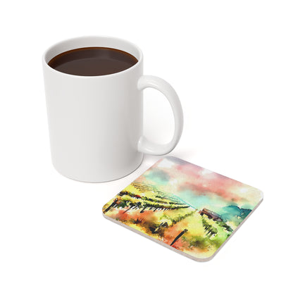 Watercolor Vineyards cork-back coaster — on a table with a mug