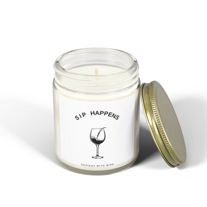 Sip Happens candle lit with the gold lid resting beside the jar on a white background
