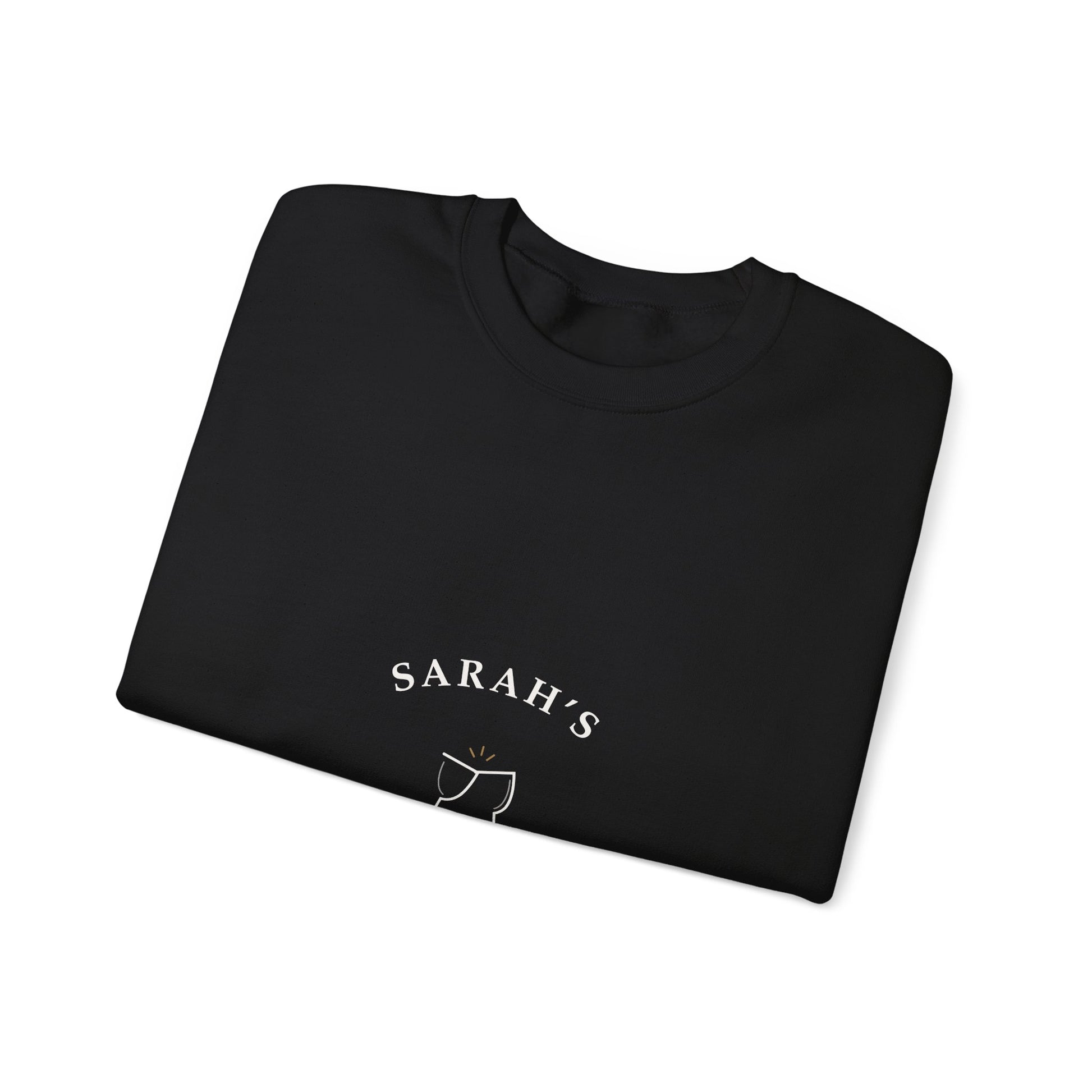 Folded black crewneck showing a close-up of the cream Weekend Wine Club lettering