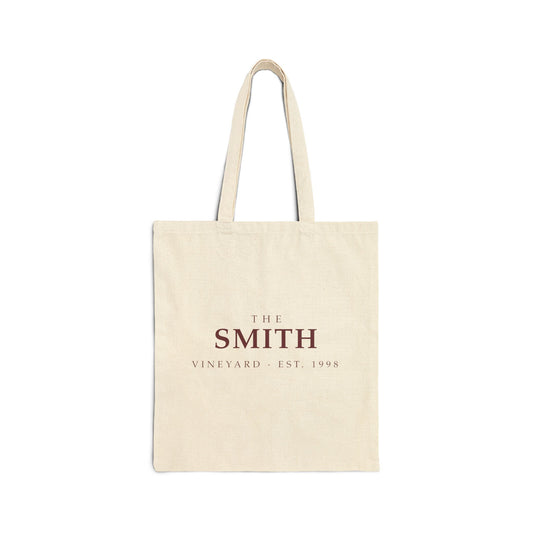 Natural cotton canvas tote bag printed with THE SMITH VINEYARD, EST. 1998 in wine-red and gold typography