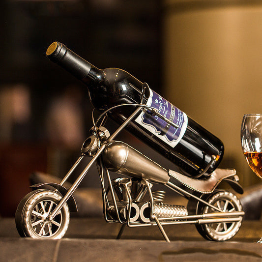Wrought iron motorcycle sculpture holding a wine bottle as a display rack