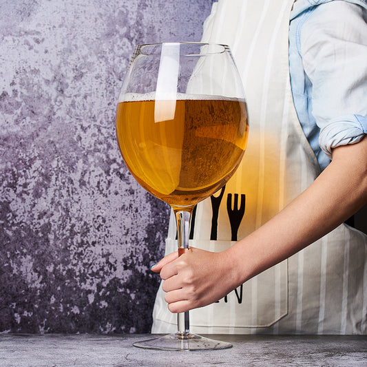 Oversized giant wine glass in clear crystal glass on a table